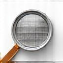 Icône d'une loupe inspectant un sol fini.